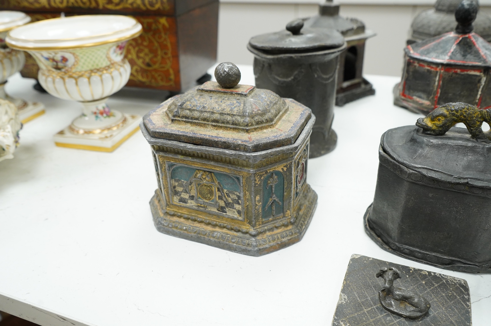 A collection of nine early 19th century lead tobacco boxes and a cover, tallest 20cm